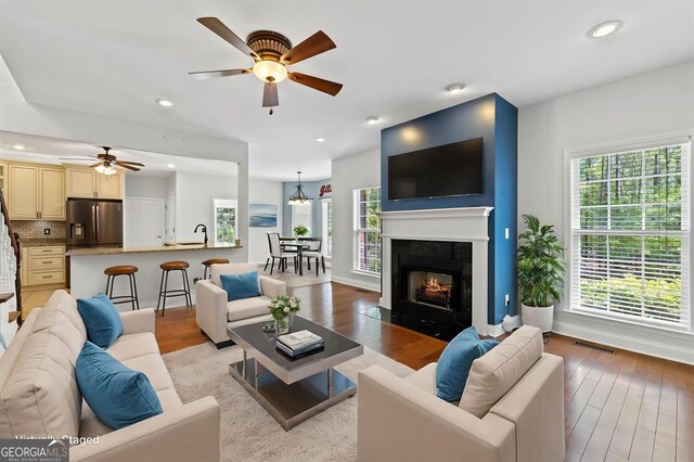 unfurnished room with visible vents, baseboards, hardwood / wood-style floors, and ceiling fan