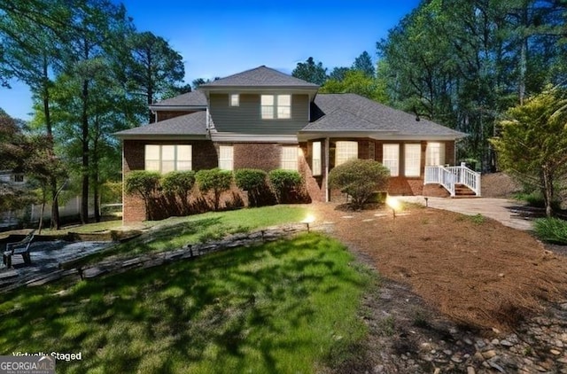 traditional-style home with covered porch and brick siding