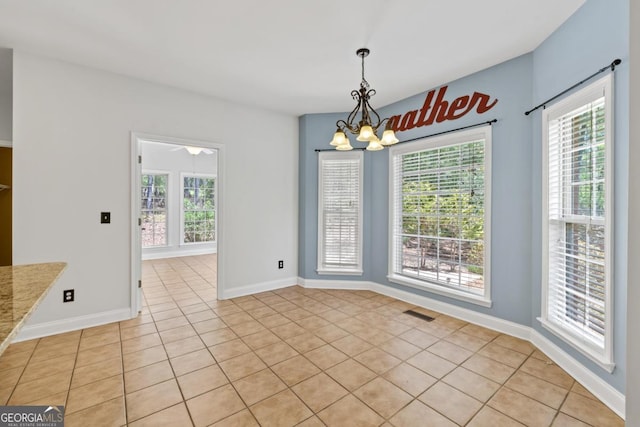 doorway with visible vents, light tile patterned floors, and a healthy amount of sunlight