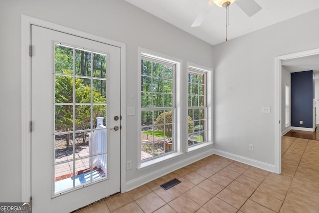 kitchen featuring stainless steel appliances, cream cabinetry, and ceiling fan