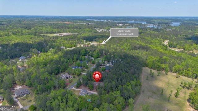 drone / aerial view featuring a forest view