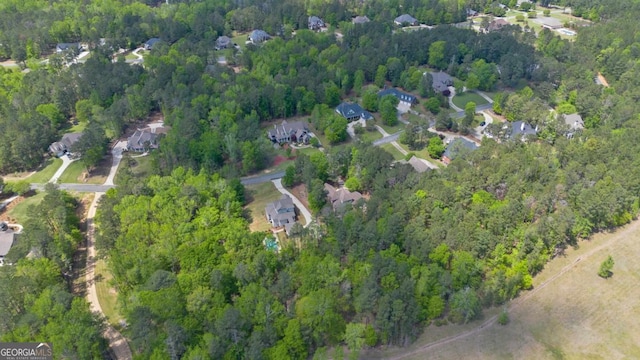drone / aerial view with a view of trees and a water view