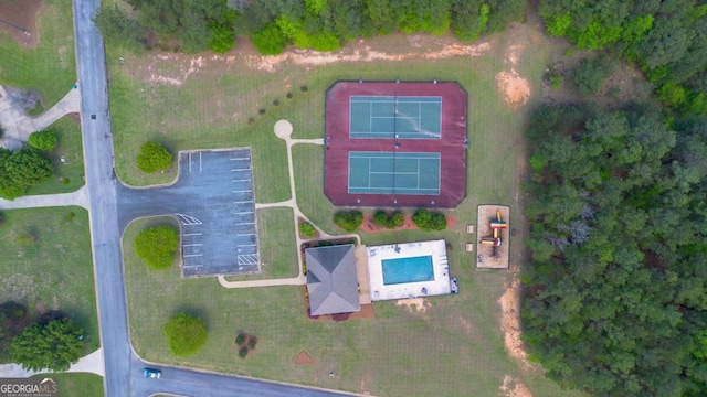 community pool featuring a patio, fence, and playground community