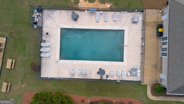 community pool featuring french doors, a patio, and fence