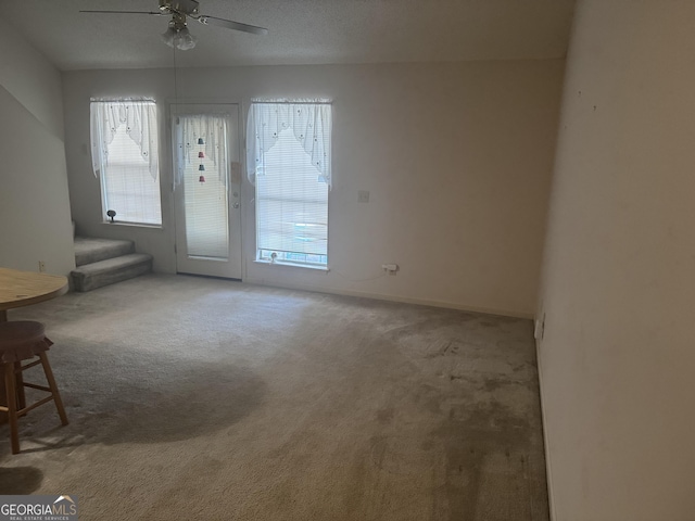 6183 Field Stone Dr, Douglasville, GA 30134 - empty room with a ceiling fan, carpet floors, and stairway