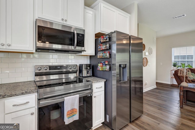 572 Brightleaf Cir, Hinesville, GA 31313 - kitchen featuring light stone counters, white cabinetry, backsplash, stainless steel appliances, and wood finished floors