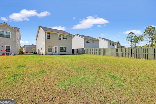 572 Brightleaf Cir, Hinesville, GA 31313 - rear view of property featuring a fenced backyard and a lawn