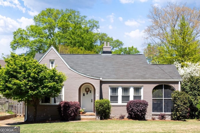 812 E Ponce De Leon Ave, Decatur, GA 30030 - tudor home with brick siding, fence, a chimney, and a front lawn