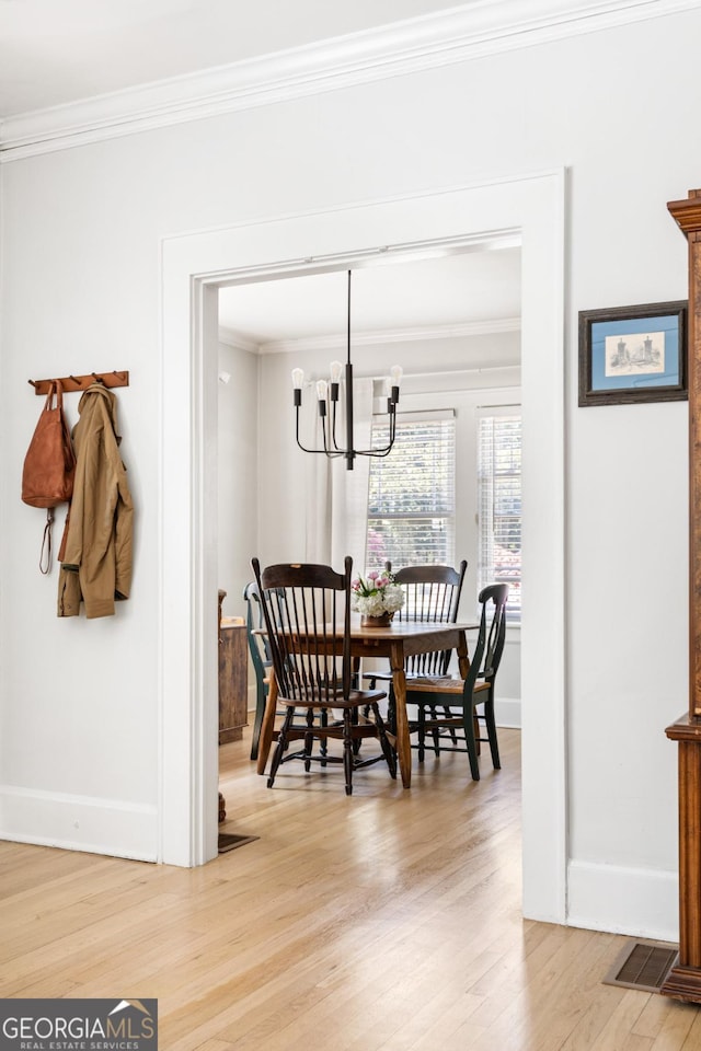 812 E Ponce De Leon Ave, Decatur, GA 30030 - dining area with baseboards, ornamental molding, light wood finished floors, and a notable chandelier