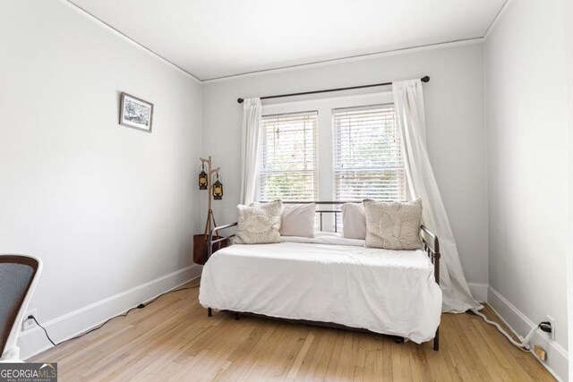 812 E Ponce De Leon Ave, Decatur, GA 30030 - bedroom featuring baseboards, ornamental molding, and light wood-style floors