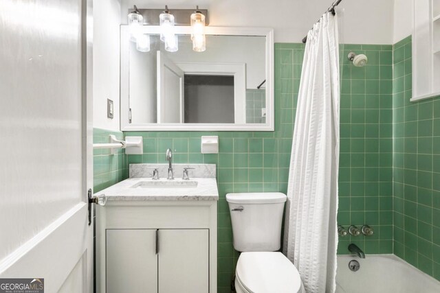 812 E Ponce De Leon Ave, Decatur, GA 30030 - bathroom with vanity, toilet, tile walls, and shower / bath combo with shower curtain