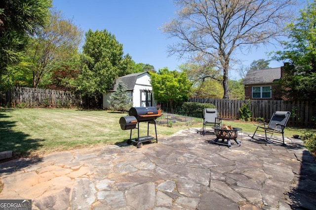 812 E Ponce De Leon Ave, Decatur, GA 30030 - fenced backyard featuring a fire pit, area for grilling, a patio, and a storage unit