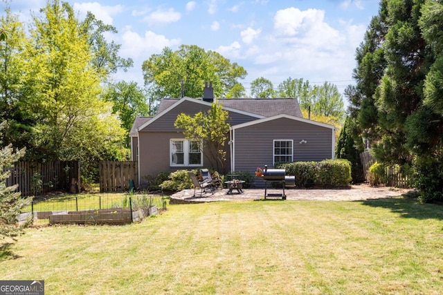 812 E Ponce De Leon Ave, Decatur, GA 30030 - back of house featuring a garden, an outdoor fire pit, a patio, and a chimney