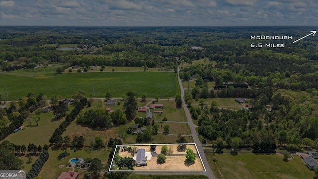 birds eye view of property featuring a view of trees