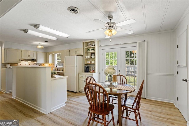 dining room featuring a ceiling fan, french doors, light wood-style floors, and visible vents