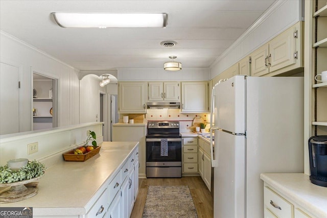 kitchen with freestanding refrigerator, visible vents, under cabinet range hood, light countertops, and stainless steel electric range