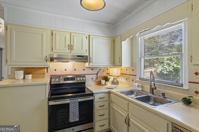 kitchen with a sink, ornamental molding, under cabinet range hood, backsplash, and electric range