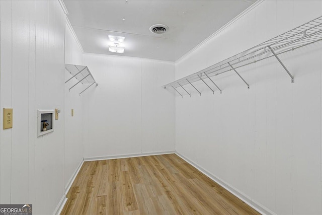 spacious closet featuring light wood-style flooring and visible vents