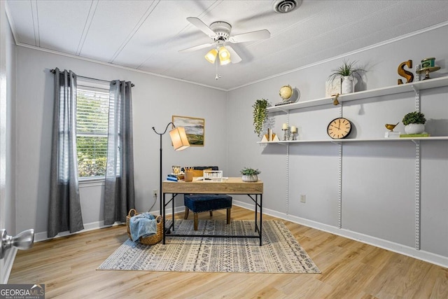 home office with visible vents, baseboards, a ceiling fan, and wood finished floors