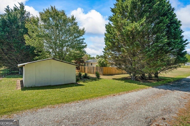 exterior space featuring an outbuilding and fence
