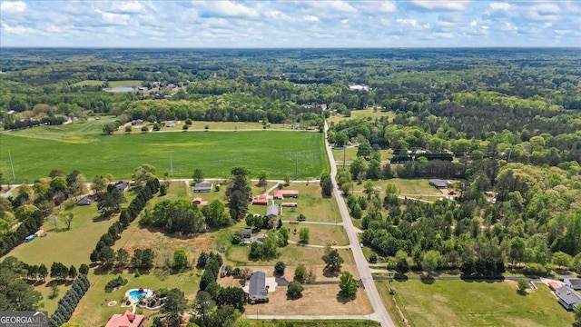 birds eye view of property featuring a wooded view