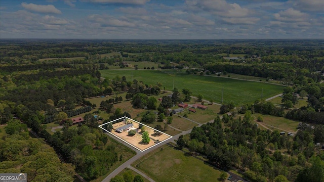 aerial view with a wooded view and a rural view