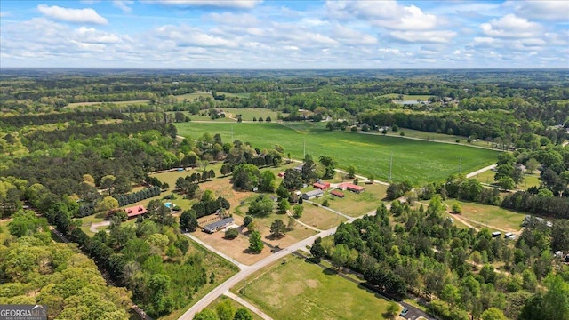 birds eye view of property with a view of trees and a rural view