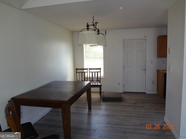 2338 Rambling Way, Lithonia, GA 30058 - unfurnished dining area with baseboards and wood finished floors