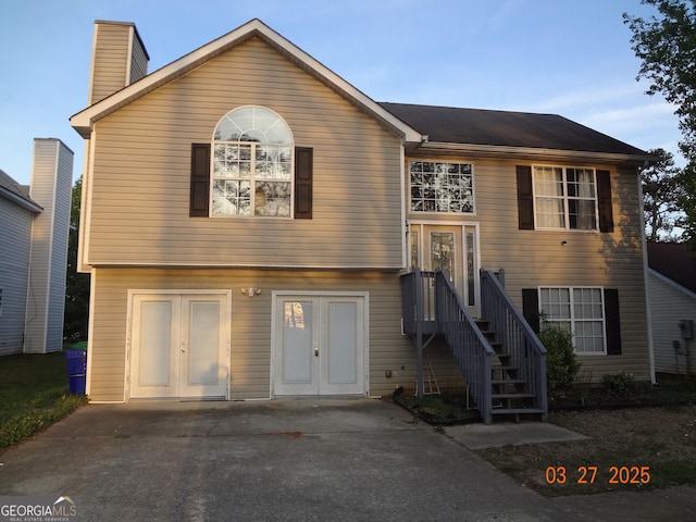 2338 Rambling Way, Lithonia, GA 30058 - raised ranch featuring french doors, stairway, and a chimney