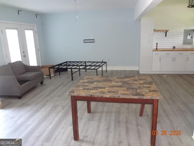 2338 Rambling Way, Lithonia, GA 30058 - living area featuring electric panel, light wood finished floors, french doors, and baseboards