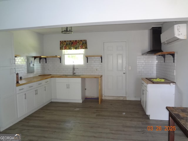 2338 Rambling Way, Lithonia, GA 30058 - kitchen with wall chimney exhaust hood, butcher block counters, open shelves, a sink, and an AC wall unit
