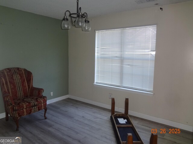 2338 Rambling Way, Lithonia, GA 30058 - living area featuring a chandelier, plenty of natural light, baseboards, and wood finished floors