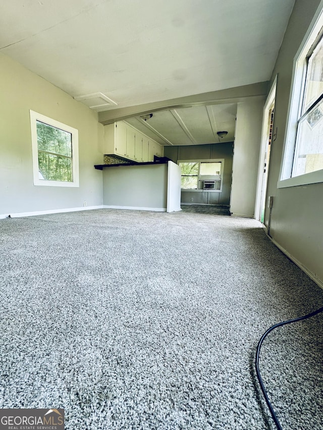 4199 Wagon Trl, Loganville, GA 30052 - unfurnished living room with plenty of natural light, baseboards, and speckled floor
