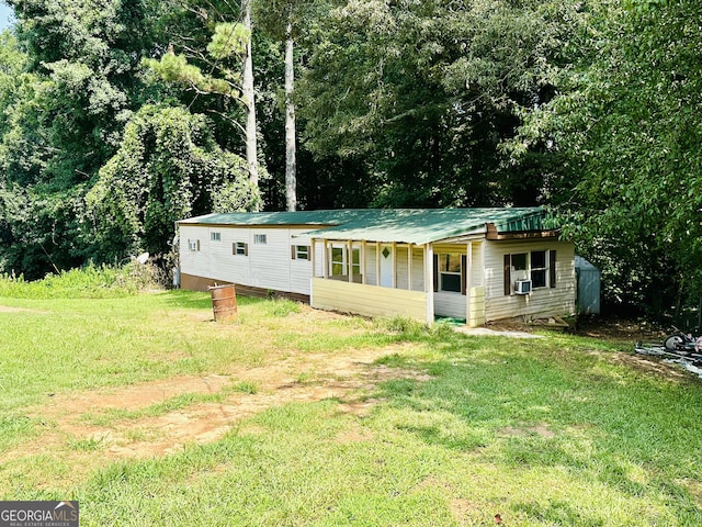 4199 Wagon Trl, Loganville, GA 30052 - view of front of house with cooling unit, metal roof, and a front lawn