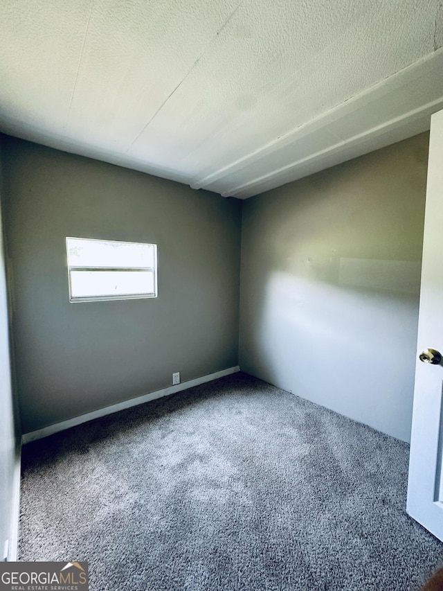 4199 Wagon Trl, Loganville, GA 30052 - unfurnished room featuring a textured ceiling and carpet floors