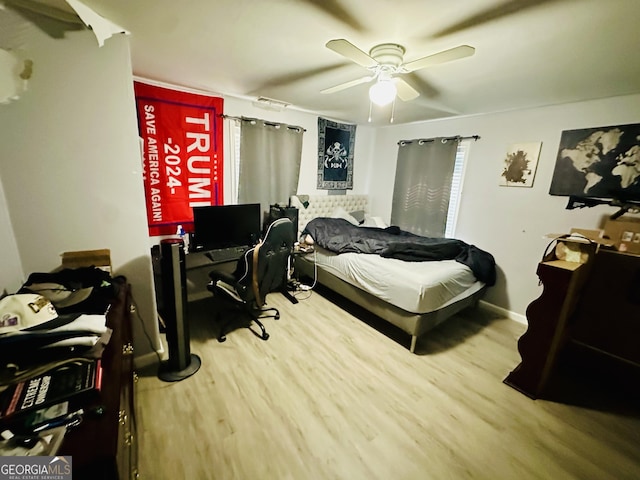 bedroom featuring ceiling fan, wood finished floors, and baseboards
