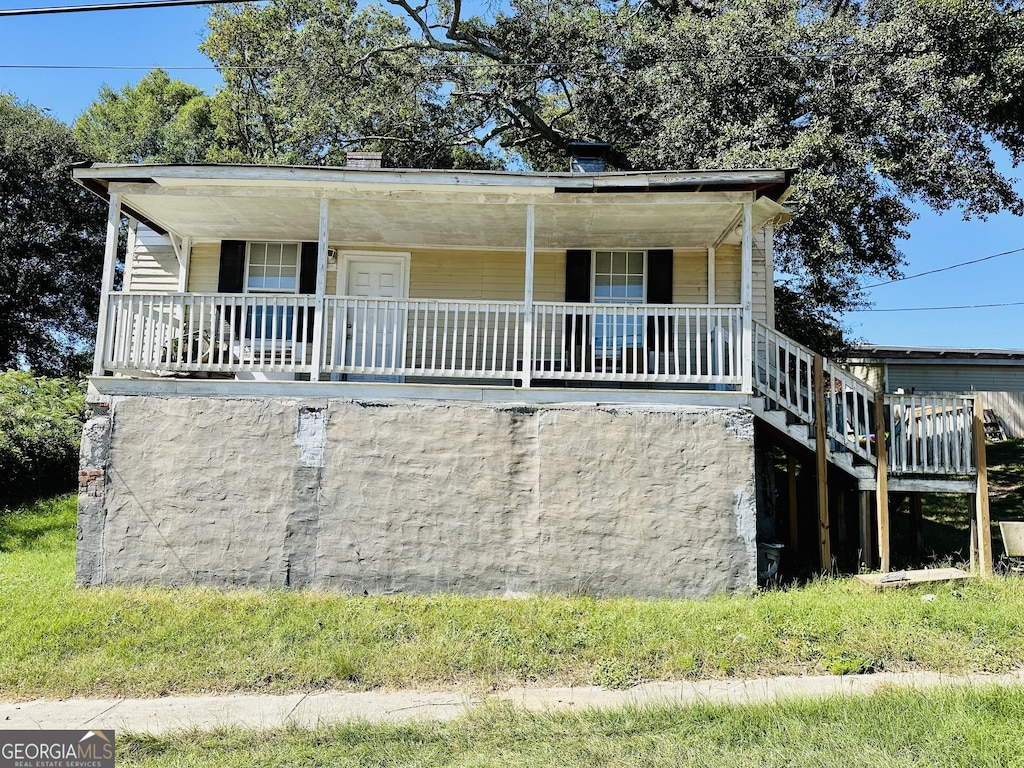 7 Ivy St, Porterdale, GA 30014 - view of front facade featuring stairs and covered porch