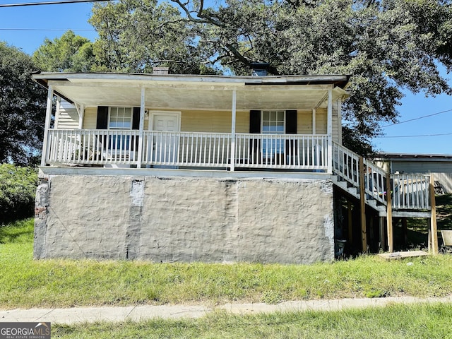 7 Ivy St, Porterdale, GA 30014 - view of front facade featuring stairs and covered porch