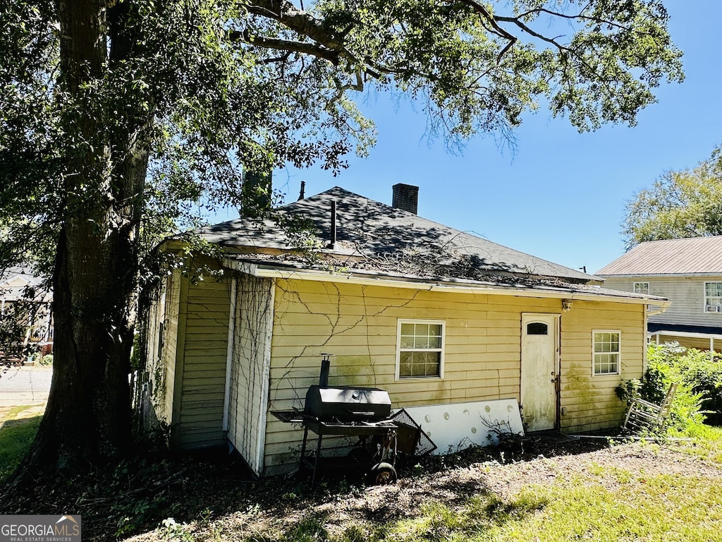 7 Ivy St, Porterdale, GA 30014 - rear view of property featuring a chimney
