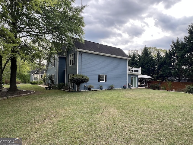 rear view of property featuring a lawn