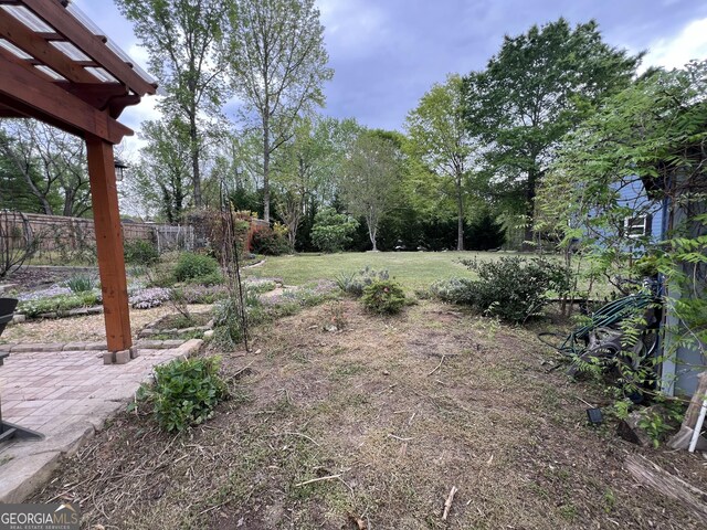 view of yard featuring fence and a patio