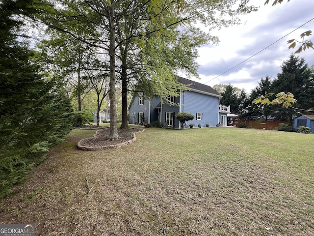 view of yard featuring an outbuilding and a storage unit