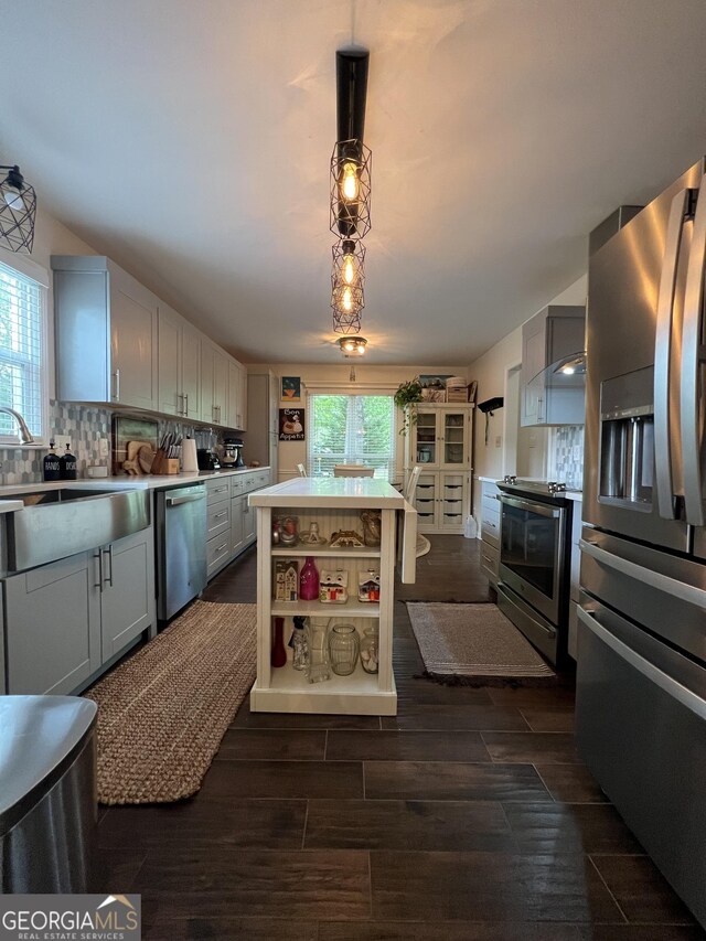 kitchen featuring plenty of natural light, light countertops, wood tiled floor, and appliances with stainless steel finishes