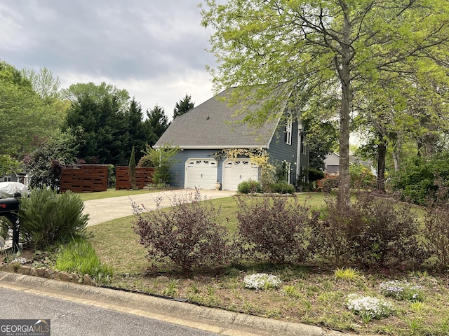 view of front of property featuring concrete driveway, fence, and a shingled roof