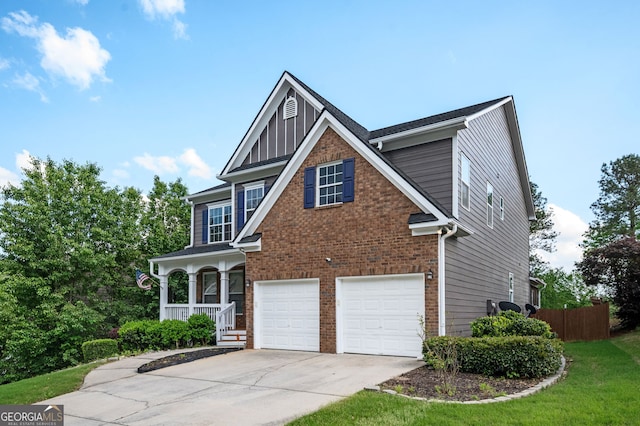67 Ryans Pt, Dallas, GA 30132 - view of front of house with driveway, a garage, brick siding, and covered porch