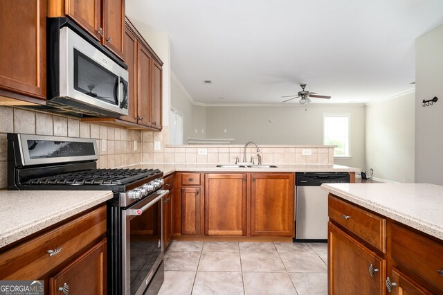 67 Ryans Pt, Dallas, GA 30132 - kitchen featuring backsplash, a ceiling fan, a sink, crown molding, and appliances with stainless steel finishes