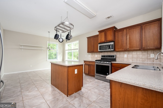 67 Ryans Pt, Dallas, GA 30132 - kitchen featuring a center island, a sink, brown cabinetry, appliances with stainless steel finishes, and visible vents