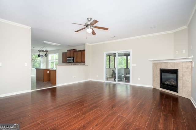 67 Ryans Pt, Dallas, GA 30132 - unfurnished living room with dark wood finished floors, a ceiling fan, ornamental molding, baseboards, and a tiled fireplace