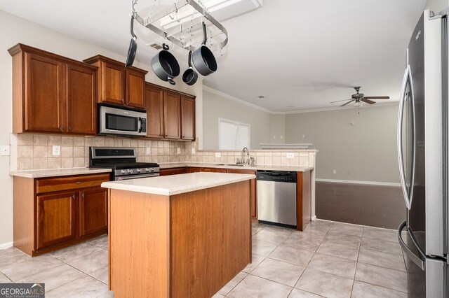 67 Ryans Pt, Dallas, GA 30132 - kitchen featuring stainless steel appliances, a peninsula, light countertops, and backsplash