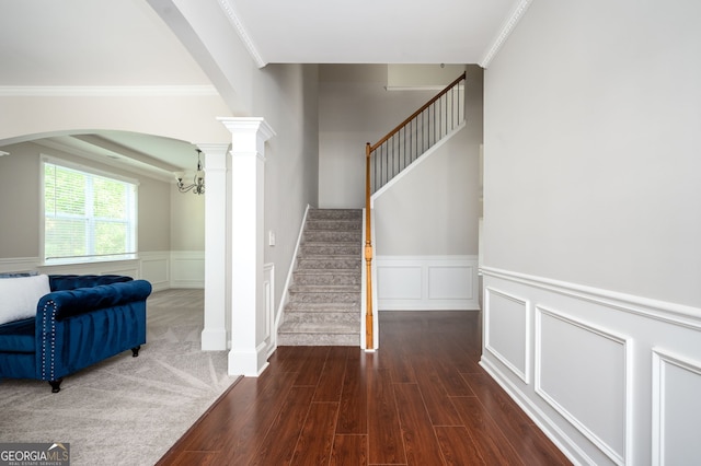 67 Ryans Pt, Dallas, GA 30132 - staircase with wood finished floors, a decorative wall, a wainscoted wall, crown molding, and arched walkways